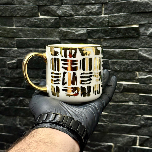Two mugs with golden linear stroke patterns