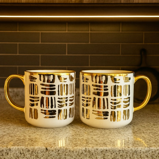 Two mugs with golden linear stroke patterns